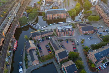 Aerial top-down sunrise view of Castlefield, Manchester with Bridgewater Canal, Rochdale Canal, and Castlefield Footbridge.