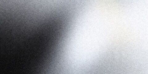 Grainy black and white gradient creating abstract texture, transitioning from dark gray to bright silvery white noise