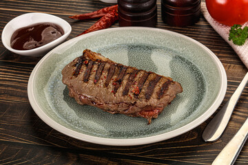 Grilled beef striploin steak with sauce
