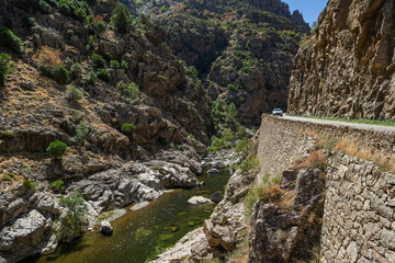 Scenic Corsica Island Mountain Road Along the River in a Rocky Canyon During Daylight