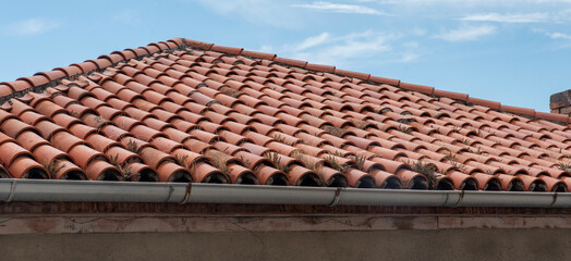 Terracotta roof tiles with metal gutter