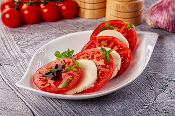 Italian caprese salad with mozzarella, tomato and basil