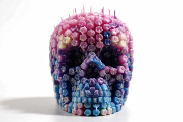 Skull candle with colorful wax drips a unique and decorative item perfect for gothic or Halloween themes