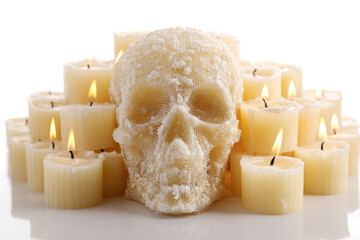 Skull candle surrounded by tea light candles spooky and decorative perfect for Halloween or gothic themes