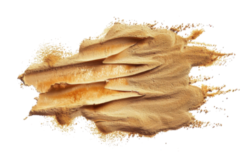 Golden mineral powder spread artistically on a white background for creative design