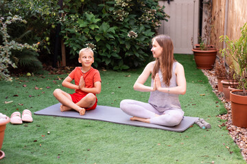 Teenage Girl and Boy Doing Yoga Together in Backyard. Family Fitness, Healthy Lifestyle