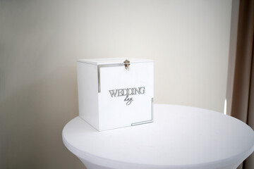 Wooden white wedding chest with the inscription 