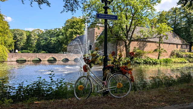 Flower decorated bicycle in front of Arcen Castle (Kasteel Arcen), Netherlands