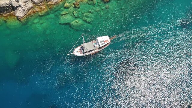 Aerial View of Anthony Quinn Bay &ndash; Boats, Crystal Waters, and Rocky Coastline