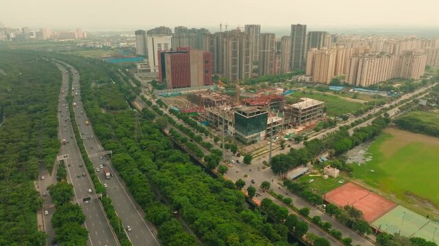 Aerial view of the bustling Noida-Greater Noida Expressway, with buildings and greenery contrasting in Noida, Uttar Pradesh, India.