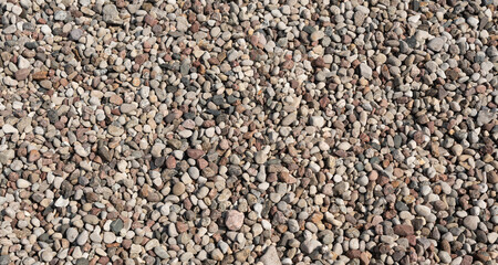 Pebble stones textured background. Small round rocks pattern top view, smooth pebble