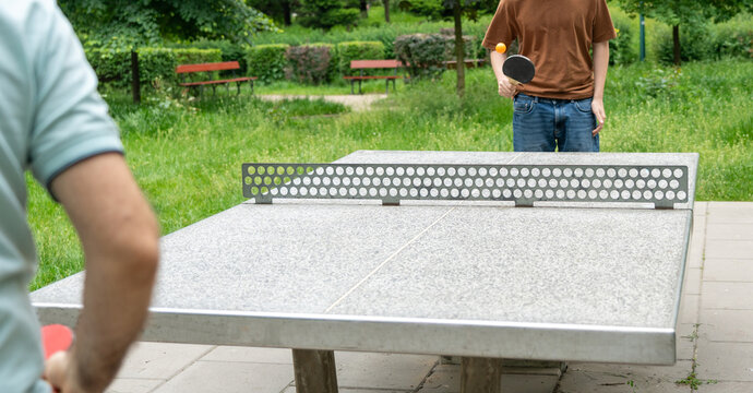 Table tennis in park. Ping pong summer sport outside, people play pingpong, table tennis game