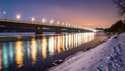 Obraz premium Bridge illuminated at night over a frozen river