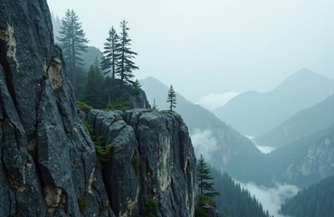 Majestic mountain landscape with rocky cliffs and evergreen trees shrouded in mist