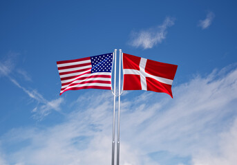 flags of  denmark and United States of America over blue sky background.