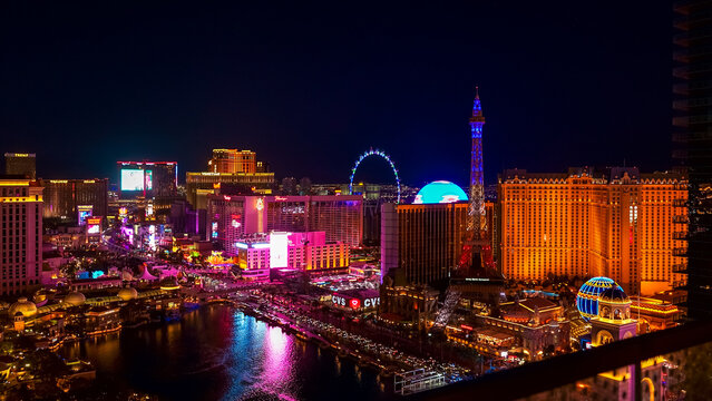 Aerial view of the vibrant Las Vegas Strip at night showcasing iconic landmarks and colorful lights with copy space for design
