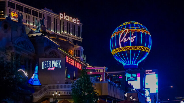 Paris Las Vegas illuminated nightlife featuring Eiffel Tower replica and vibrant hot air balloon, showcasing the city's iconic attractions and lively atmosphere
