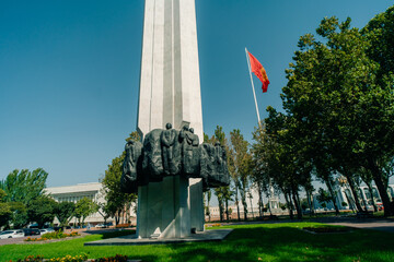 Detail of the national flag of Kyrgyzstan waving in the wind on a clear day.