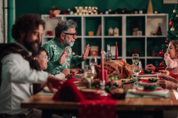 Family enjoying christmas dinner with roasted turkey and festive decorations