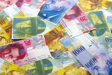 Swiss franc banknotes. The current francs money bills lies on table in big amount. The concept of...