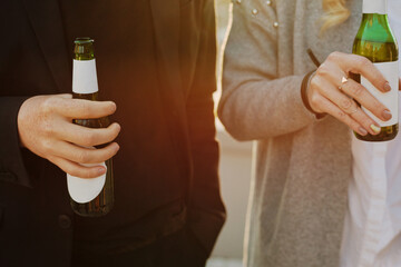 Hangout with beer. Conceptual crop shot of unrecognizable man and woman holding bottles of beer outdoors