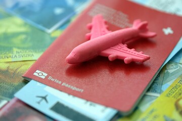 Swiss franc banknotes and passport with tickets. The current francs money bills and biometrical pass lies on table in big amount. The concept of travel and vacation in Switzerland