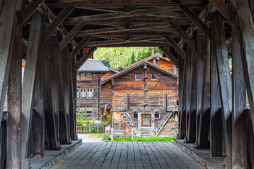 View of the town of Reckingen in Switzerland seen from the wooden bridge across river rotten