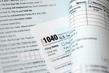 Fototapeta premium 1040 US individual income tax return form blank close up. Few pages of united states tax blank. Concept of taxpaying and accounting in United States