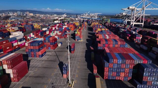 Oakland, United States - 20 September 2025: Aerial view of shipping containers stacked high in vibrant hues, contrasting with the industrial port setting.