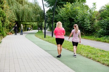 Women enjoying time outdoors while walking in a park, everyday moments