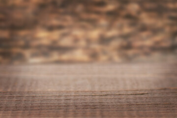 Rustic wooden table on warm brown surface with blurred background for home and cafe scenes