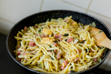 Bami Goreng Stir Fry Noodles with Ham, Leek and Egg Omelette in a Pan, Indonesian Restaurant Food Cuisine