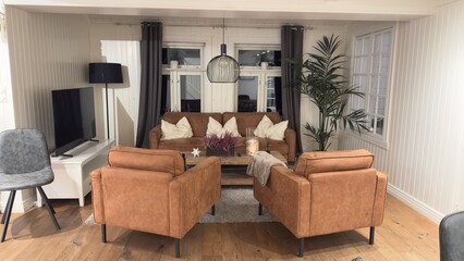 Cozy Hotel Lobby with Armchairs, Sofa, and Decorative Accents 09.17.2025 Norway Warm and inviting hotel lobby featuring two armchairs, a sofa with cushions, flowers, and candles. 