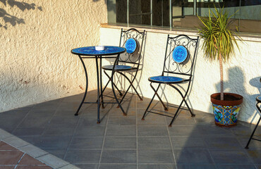 Outdoor patio furniture in sunny Sicilian garden