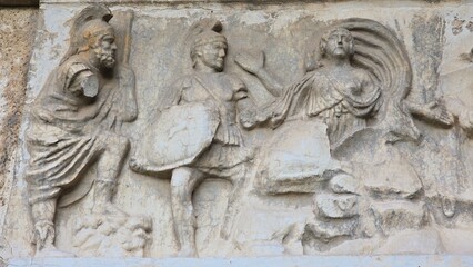 Rome, Italy – 13 January 2025. At Basilica Emilia, a carved marble panel features Roman soldiers...