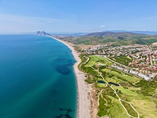 aerial photp of the golf course directly at the coast of the Mediterranean Sea in La Alcaidesa with a view towards the Rock of Gibraltar, Andalusia, Malaga, Spain	