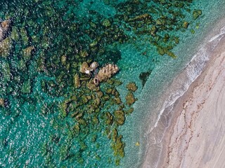 aerial view of a coast with beach by the blue Mediterranean Sea with rocks, Andalusia, Spain