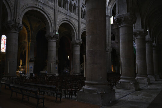 View of stone arches and columns inside historic cathedral in Macon France 