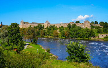 Fototapeta premium Ivangorod Fortress, a Russian medieval castle located on the banks of the Narva river in the Leningrad Oblast across the International border with Estonia and the EU