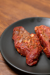 Close-Up of Marinated Raw Steak on a Plate

