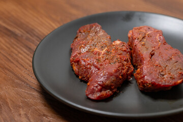 Close-Up of Marinated Raw Steak on a Plate
