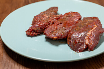 Close-Up of Marinated Raw Steak on a Plate
