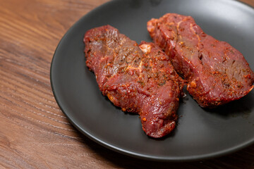 Close-Up of Marinated Raw Steak on a Plate
