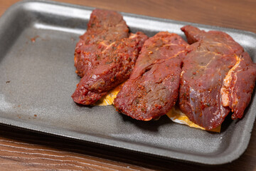 Close-Up of Marinated Raw Steak on a Plate

