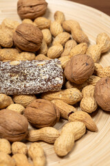 Close-Up of a Coconut Protein Bar with Peanuts and Walnuts
