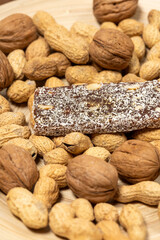 Close-Up of a Coconut Protein Bar with Peanuts and Walnuts
