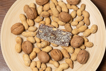 Close-Up of a Coconut Protein Bar with Peanuts and Walnuts
