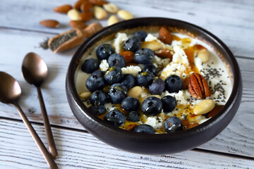 Cottage cheese and yogurt bowl with nuts and blueberries