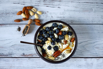 Cottage cheese and yogurt bowl with nuts and blueberries