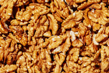 Peeled brown walnut kernels background close-up top view, vegetable protein, healthy eating